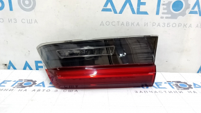 The right inner taillight of a BMW 3 G20 19-21 is worn and scratched.