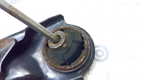 The lower front left control arm of a Nissan Rogue Sport 17-22 under R19 has a torn silent block.