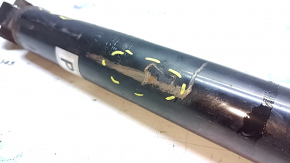 The rear left shock absorber of the Nissan Rogue Sport 17-22 is dented.