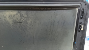The sunroof glass of a BMW 3 G20 19-24 is covered in soot.