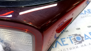 The upper right wing light of a Toyota Prius 50 19-22 is missing a chip and has scratches.