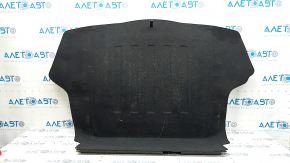The trunk floor of a 2016-2017 Kia Optima is black, worn, has dents, and needs cleaning.
