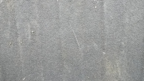 The trunk floor of a 2016-2017 Kia Optima is black, worn, has dents, and needs cleaning.