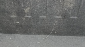 The trunk floor of a 2016-2017 Kia Optima is black, worn, has dents, and needs cleaning.
