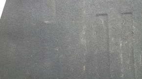 The trunk floor of a 2016-2017 Kia Optima is black, worn, has dents, and needs cleaning.