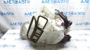 The bare heater housing of a Nissan Rogue Sport 19-22 dual zone for heated seats has cracks and a broken latch.