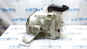 The bare heater housing of a Nissan Rogue Sport 19-22 dual zone for heated seats has cracks and a broken latch.