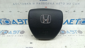 The steering wheel airbag for the driver's side of a 1993 Honda Accord is black and scratched.