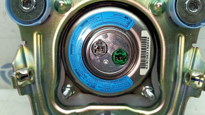 The steering wheel airbag for the driver's side of a 1993 Honda Accord is black and scratched.
