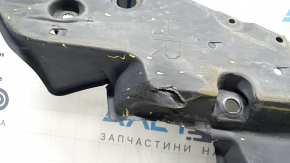The front right underbody protection of Toyota Venza 21-24 is dented, scuffed, and has tears.
