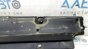 The front right underbody protection of Toyota Venza 21-24 is dented, scuffed, and has tears.