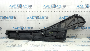 The front right underbody protection of Toyota Venza 21-24 is dented, scuffed, and has tears.