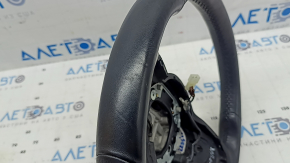 The steering wheel of a Mercedes GLC 20-22 is bare, black leather, heated, with scratches, tears, and dents.