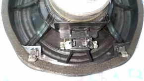 The left speaker on the rear shelf of a Honda Accord 13-17 is dented, with chips on the edge.