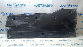 Right underbody protection for VW Jetta 19-24 is worn and dented.