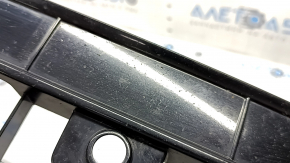 The lower grille of the front bumper, central, VW Tiguan 18-21, under parking sensors, R-Line, is cracked, sand