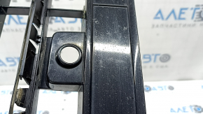The lower grille of the front bumper, central, VW Tiguan 18-21, under parking sensors, R-Line, is cracked, sand