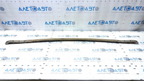 The rear beam strut of a Toyota Prius V 12-17 is dented and rusty.