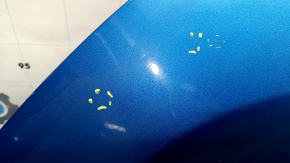 The bare hood of a Hyundai Tucson 16-21 blue R2U, steel, paint chips, bump