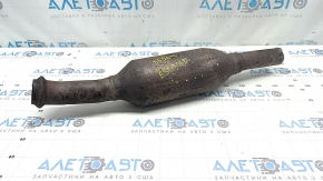 The rear catalytic converter of a Ford Escape MK4 2023-25 hybrid is sawn off, rusty, and dented.