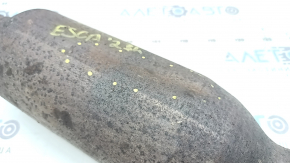 The rear catalytic converter of a Ford Escape MK4 2023-25 hybrid is sawn off, rusty, and dented.