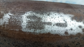 The rear catalytic converter of a Ford Escape MK4 2023-25 hybrid is sawn off, rusty, and dented.