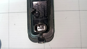 The left tailgate license plate light on a Jeep Grand Cherokee WL 21-25 has a broken mount.