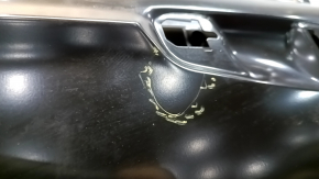 The front left door of a Ford Fusion mk5 13-20 China is bare and dented.