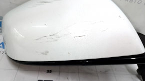 The right side mirror assembly for a Tesla Model X 22-25 is worn and scratched.