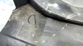 The front left fender liner, lower part, BMW X5 G05 19-24, is dented.