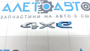 The Jeep Grand Cherokee WL 22-23 PHEV tailgate 4XE emblem is chrome. The "4" is dented.