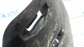 The rear lower control arm trim, right BMW X5 G05 19-24, is torn and dented.