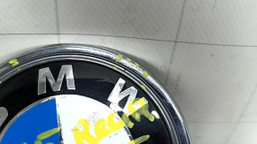 The BMW X3 F25 11-17 trunk lid emblem has broken guides.
