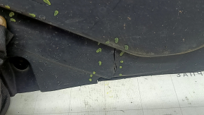The rear left underbody protection of a BMW X5 G05 19-24 is dented and cracked.