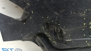 The rear left underbody protection of a BMW X5 G05 19-24 is dented and cracked.