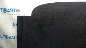 The trunk floor of a 2023-2024 Honda Accord is black and has tears in it. It needs cleaning.