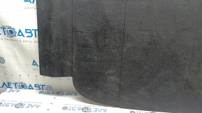 The trunk floor of a 2023-2024 Honda Accord is black and has tears in it. It needs cleaning.