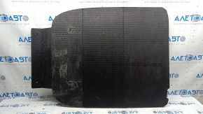 The trunk floor of a 2023-2024 Honda Accord is black and has tears in it. It needs cleaning.