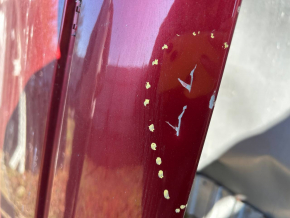 The metal roof of a Nissan Leaf 11-17 is sawn off, with dents, scratches, and dings.
