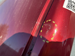 The metal roof of a Nissan Leaf 11-17 is sawn off, with dents, scratches, and dings.