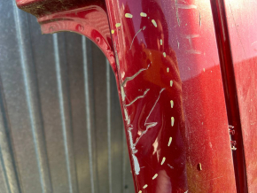 The metal roof of a Nissan Leaf 11-17 is sawn off, with dents, scratches, and dings.