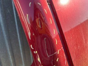 The metal roof of a Nissan Leaf 11-17 is sawn off, with dents, scratches, and dings.