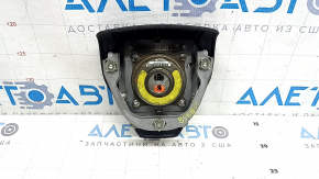 The driver's side airbag in the steering wheel of a Lexus RX350 RX450h 10-12 pre-restyling is black, the chrome is peeling, and there are scratches.