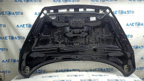 The hood of a Ford Escape MK3 2017-2019 is bare and black, with scratches and scuffs.
