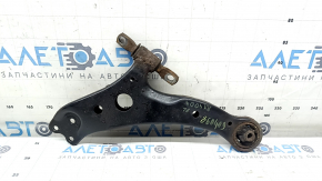 The lower front left control arm of a Lexus RX300 RX330 RX350 RX400h 04-09 has a torn silent block and is rusty.