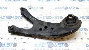 The rear right longitudinal control arm of a Lexus RX350 RX450H 10-15 has a torn silent block and is rusty.