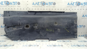 Front left underbody protection for Mazda 3 19-24 is worn and dented.