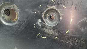 Front left underbody protection for Mazda 3 19-24 is worn and dented.