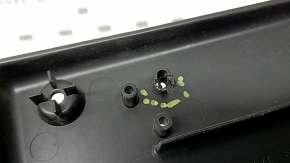 The front license plate plate of a Jaguar F-Pace X761 17-20 Sport is dented and the fasteners are broken.