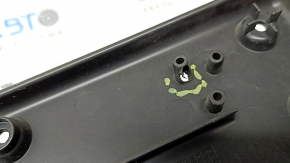 The front license plate plate of a Jaguar F-Pace X761 17-20 Sport is dented and the fasteners are broken.